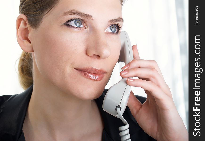 Young beautiful businesswoman speaking on the telephone. Young beautiful businesswoman speaking on the telephone