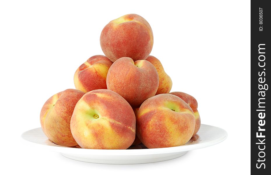 Lots of peaches on a plate isolated on white