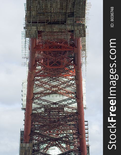 The intricate mesh of modern scaffolding and the over-engineered structure of the Forth Rail Bridge, which spans the Firth of Forth in Scotland. The intricate mesh of modern scaffolding and the over-engineered structure of the Forth Rail Bridge, which spans the Firth of Forth in Scotland