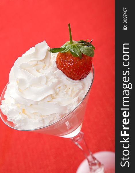 Strawberries in the glass full of white cream