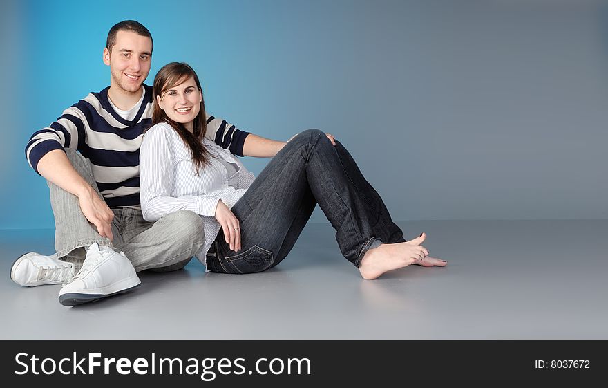 Attractive young couple sitting, enjoying a romantic moment. Attractive young couple sitting, enjoying a romantic moment