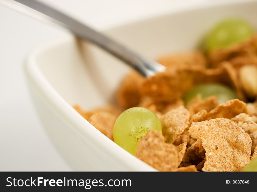 Bowl of granola cereal with fresh grape spoon. Bowl of granola cereal with fresh grape spoon