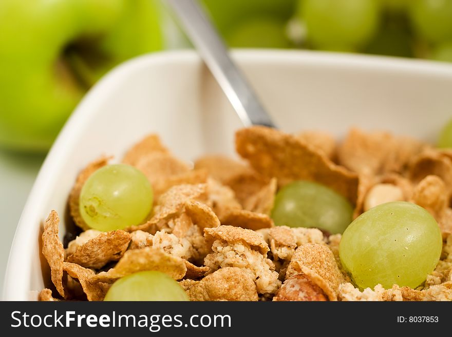 Bowl of granola cereal with fresh grape spoon. Bowl of granola cereal with fresh grape spoon