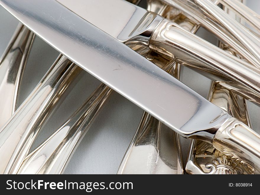 A mix of silver flatware on a white background. A mix of silver flatware on a white background