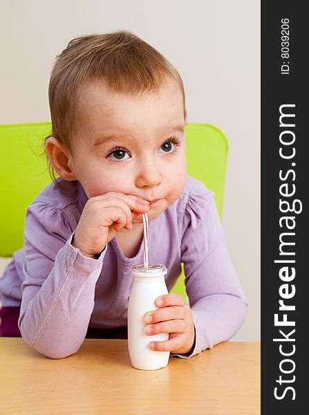 Little girl with cup of milk