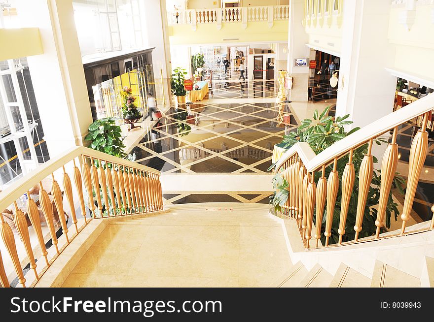 The spacious luxury hotel lobby with curving staircase. The spacious luxury hotel lobby with curving staircase.
