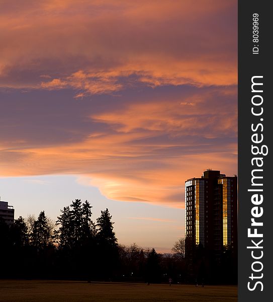 Vibrant sunset over park with buildings. Vibrant sunset over park with buildings