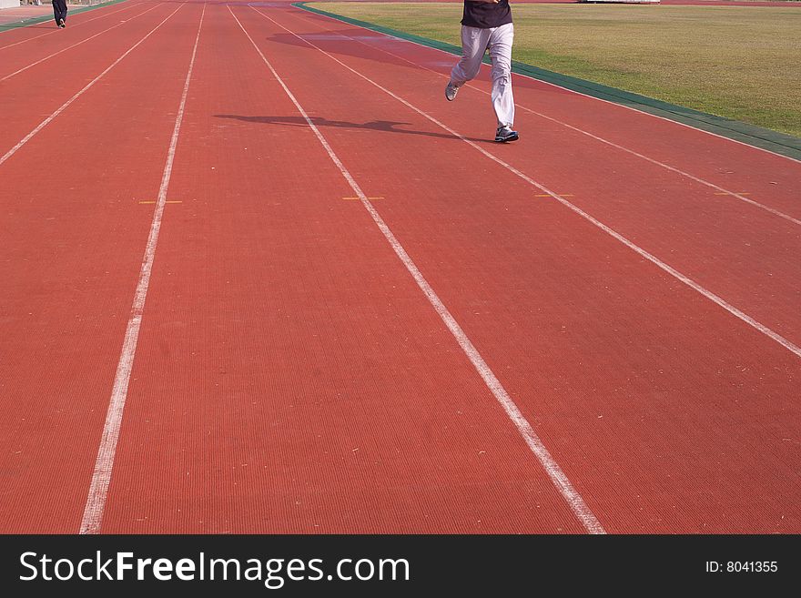 People are running on the playground to make body fitter and fitter. People are running on the playground to make body fitter and fitter.