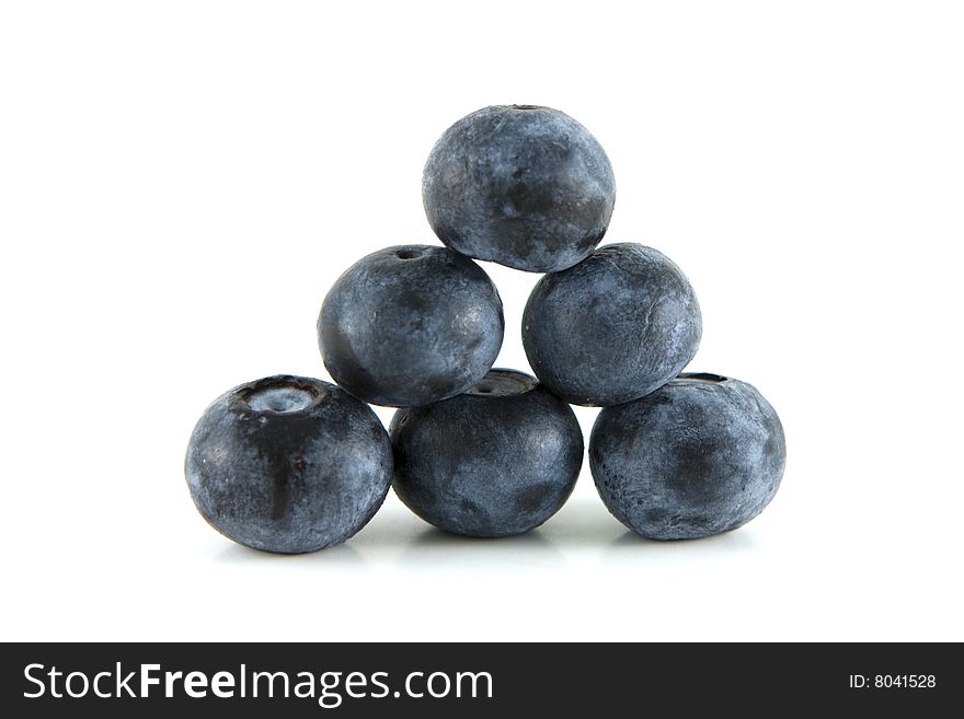 Pyramid stack of blueberries on white background.