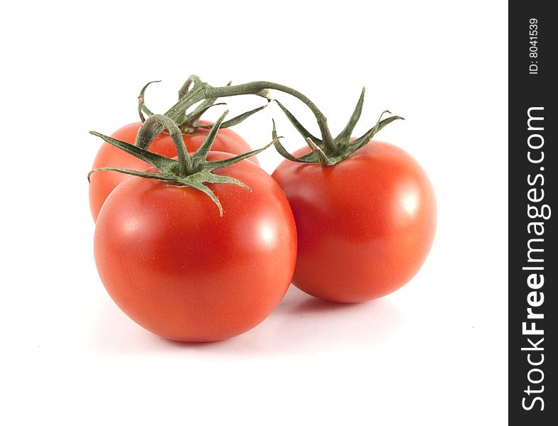 Red tomatoes connected by the vine