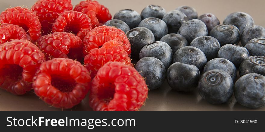 Close up of blueberries and raspberries. Shallow depth of field