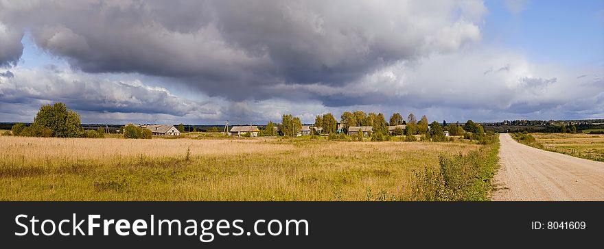 Rainbow on background of the rural landscape