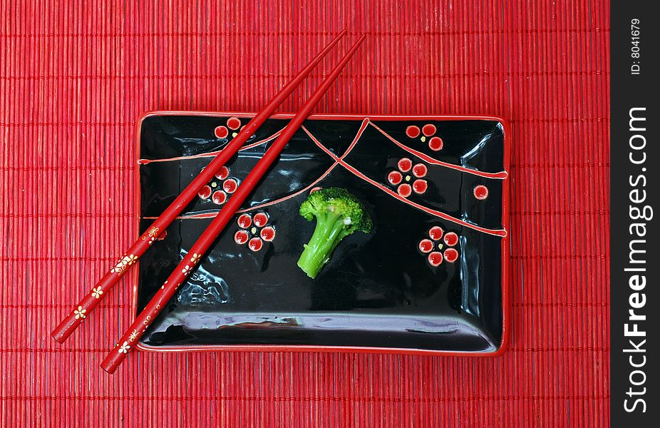 Set of black chinese ceramics kitchen utensils and broccoli