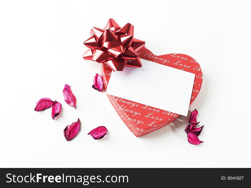 Heart shaped gift box with white note on it. Heart shaped gift box with white note on it