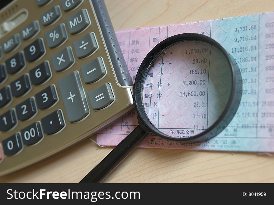 Calculator And Magnifier On Bankbook
