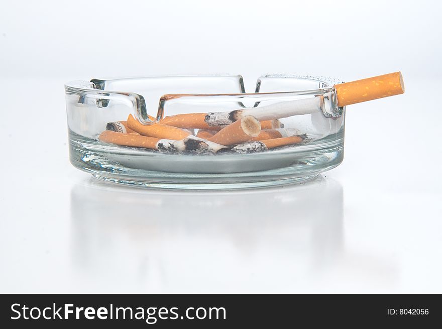 Cigarettes butts laying in ashtray. Cigarettes butts laying in ashtray