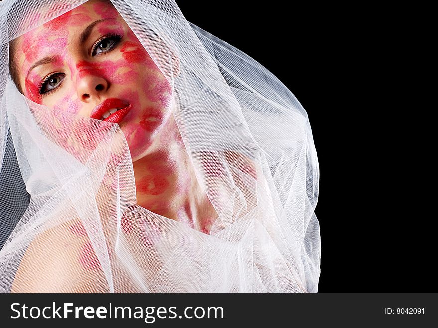 Woman with stamps of lipstick on her face and veil. Woman with stamps of lipstick on her face and veil