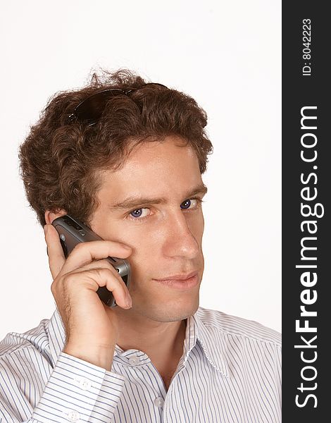 Business man talking on mobile phone with blue eyes and short brown hair. Business man talking on mobile phone with blue eyes and short brown hair