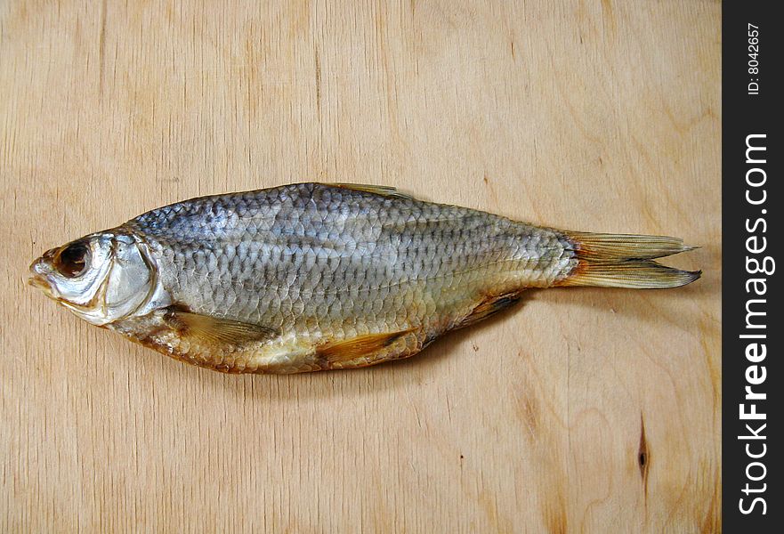 The dried fish on the wood table