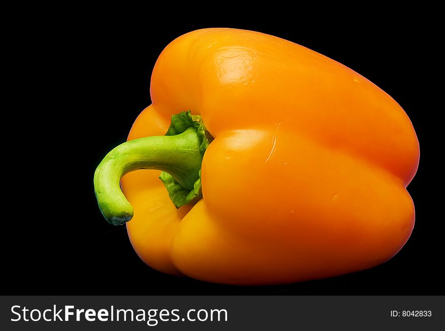 Fresh yellow orange paprika isolated on black