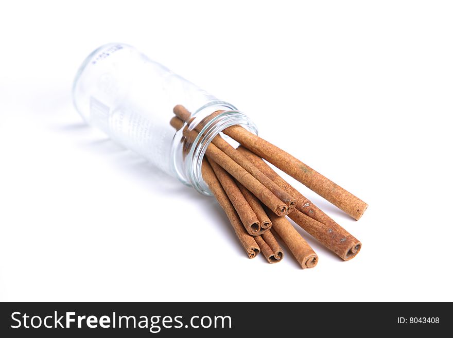 Cinnamon sticks spilled out of a jar