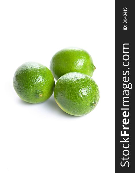 Limes cut in half isolated on white