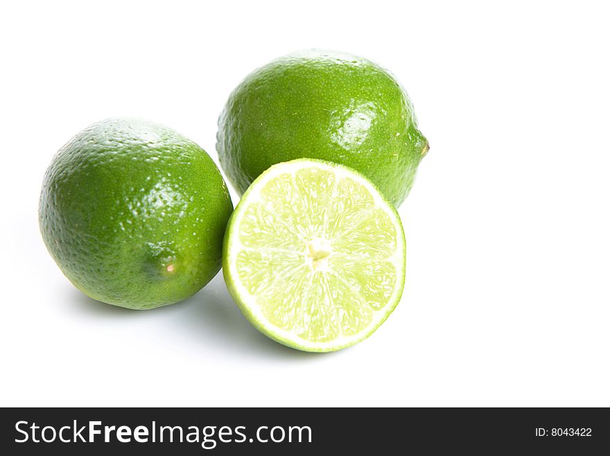 Limes cut in half isolated on white