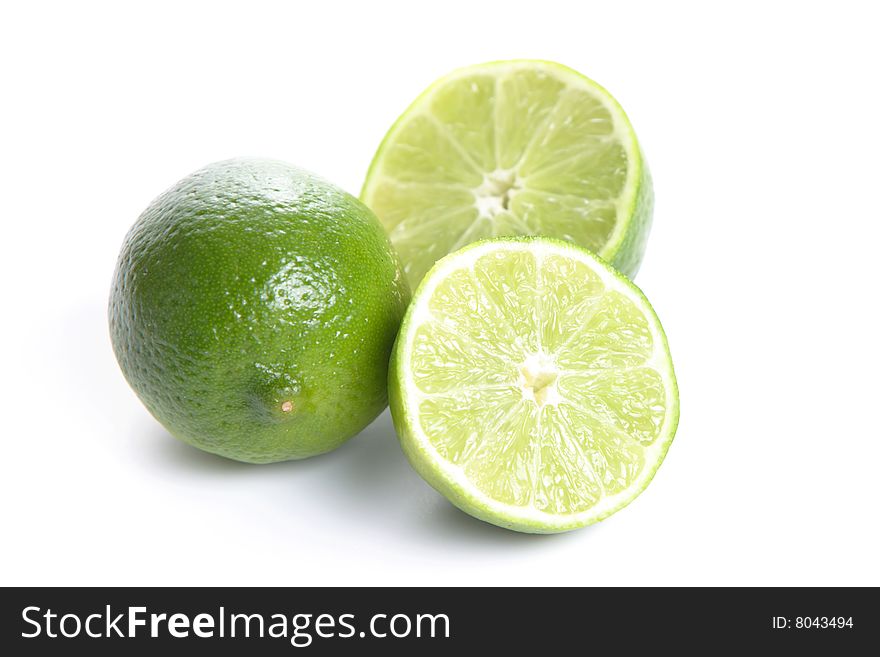 Limes cut in half isolated on white