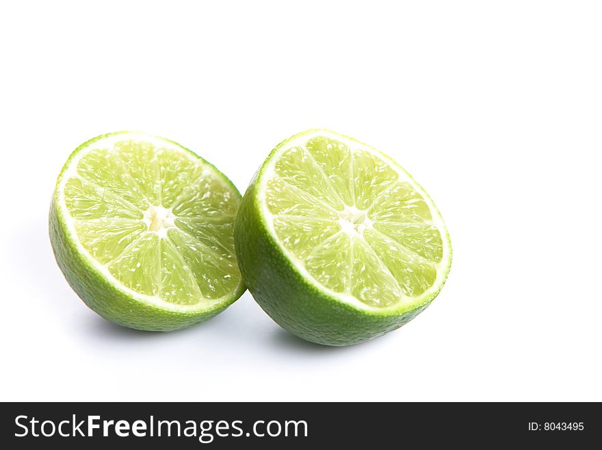 Limes cut in half isolated on white