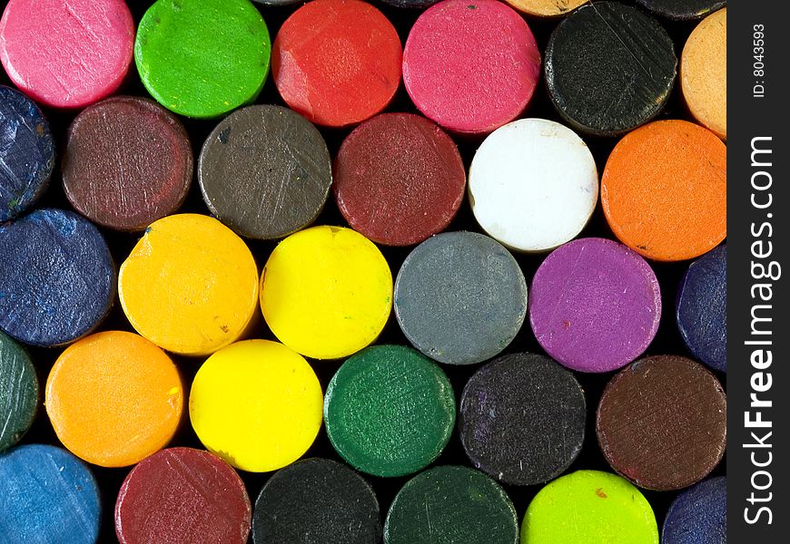 Pile of colored crayons photographed from the bottom.