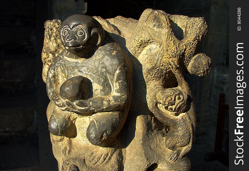 Stone carvings of a monkey with peach in hands,China's traditional crafts. Stone carvings of a monkey with peach in hands,China's traditional crafts