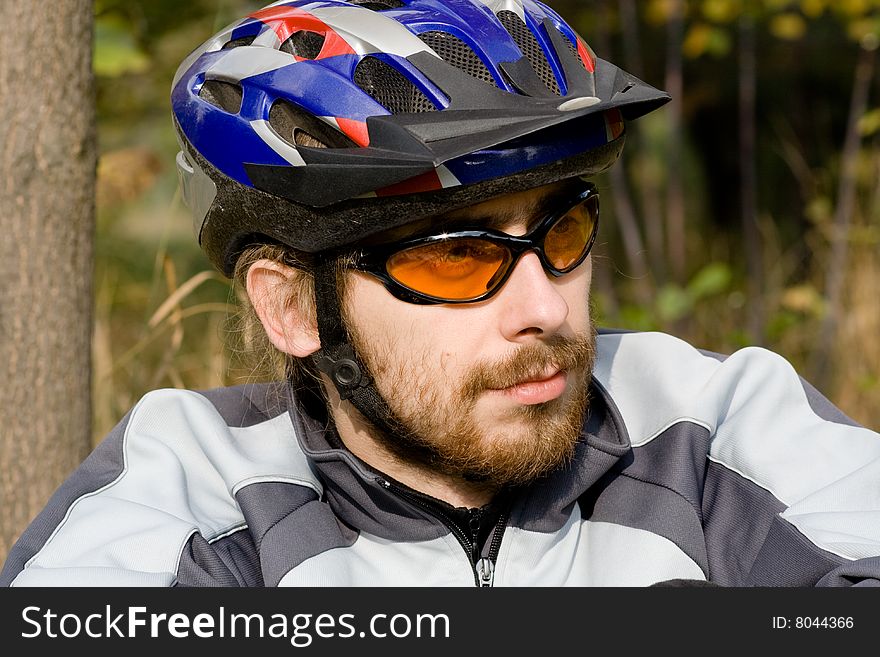 Young adoult bicycler sitting in the park