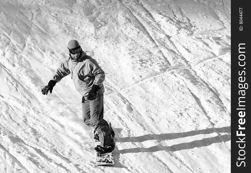 Snowboarder going down on the slope