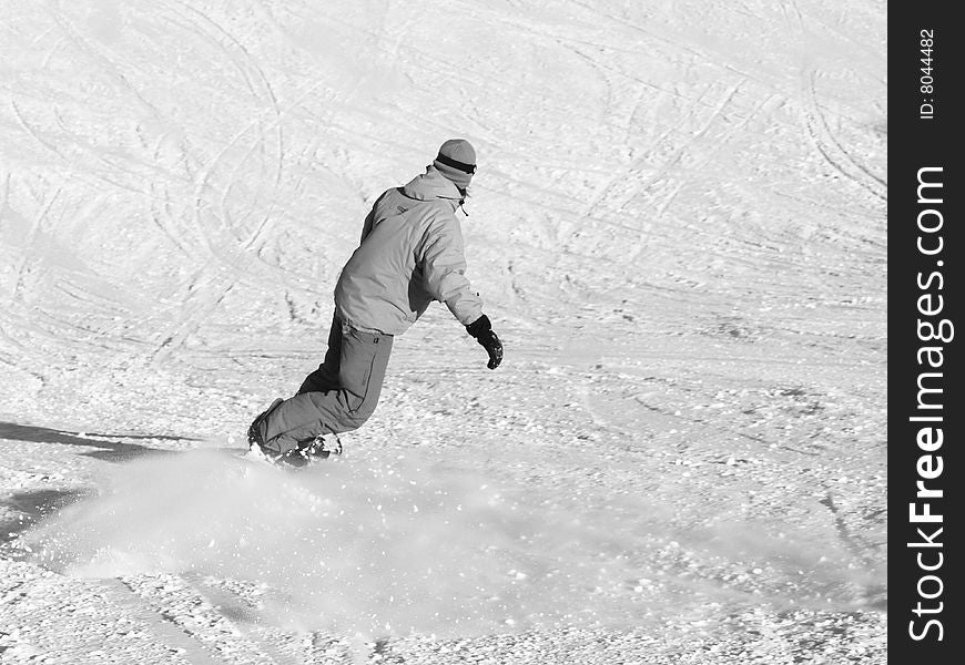 Snowboarder going down on the slope