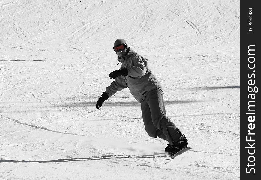 Snowboarder going down on the slope