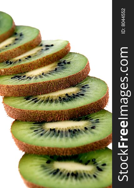 Beautiful green texture consisting of slices of kiwifruit on a white background