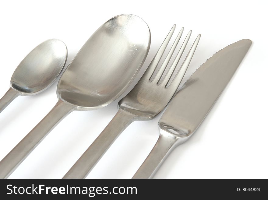 Spoons , knife and fork isolated over white , close-up. Spoons , knife and fork isolated over white , close-up