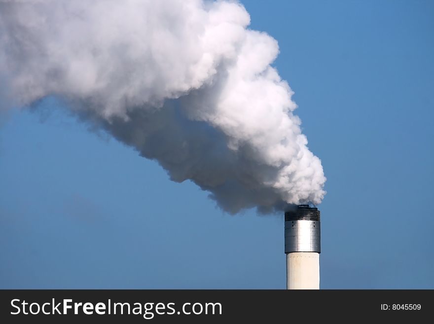 Chimney with smoke on with blue sky. Chimney with smoke on with blue sky