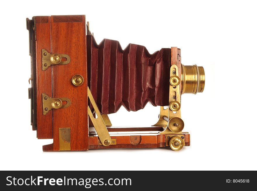 Very Old Camera on a wooden tripod on a white background