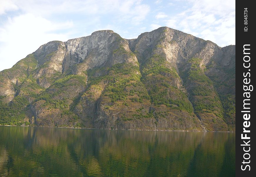 Small mountain looks over a lake in Norway