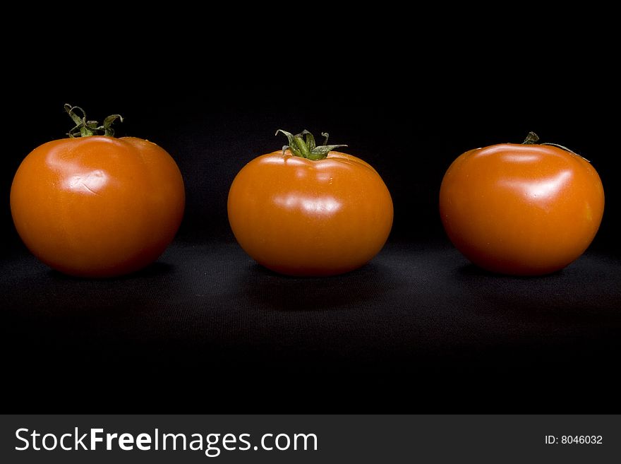 Tomatos on black not isolated background. Tomatos on black not isolated background
