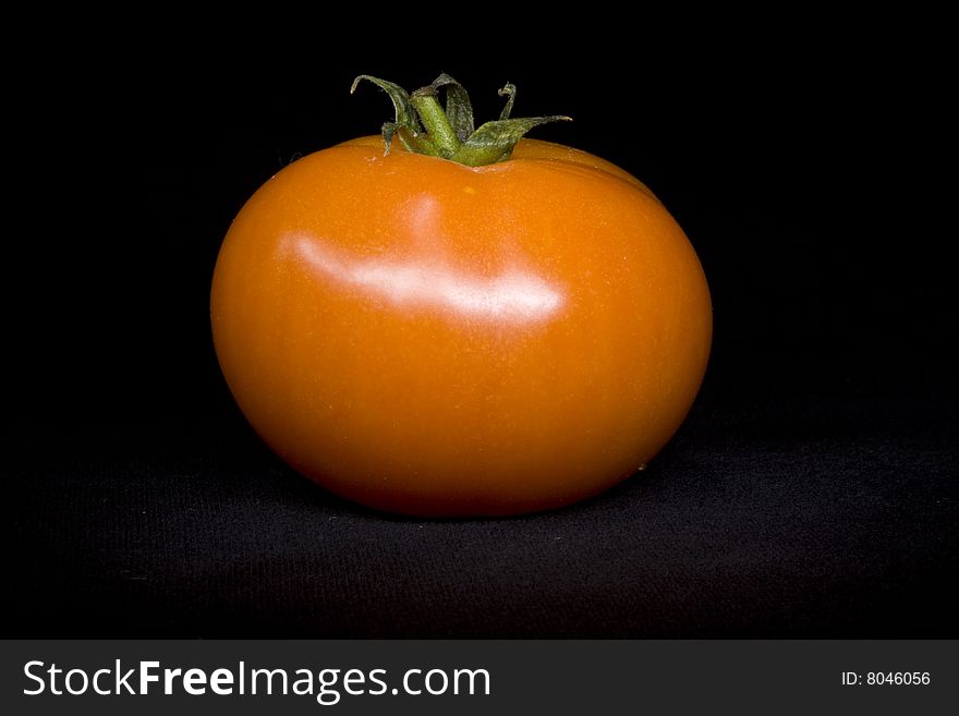 Tomato single on black not isolated background. Tomato single on black not isolated background