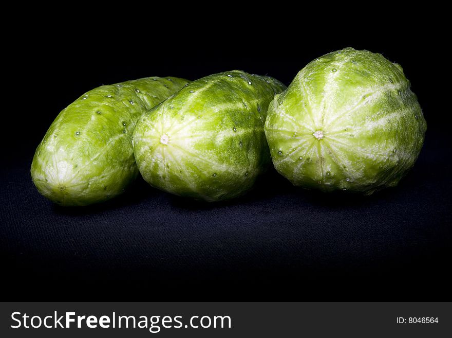 Fresh Cucumbers on black not isolated background.