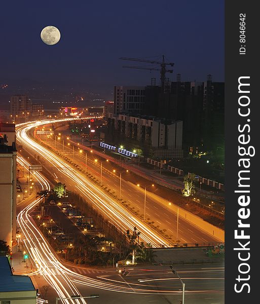 It is the night scene of Foshan city.under the moon,a road leading there from here. It is the night scene of Foshan city.under the moon,a road leading there from here.