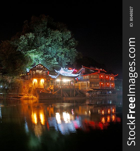 Is Chinese Hunan, Phoenix in evening hereï¼Œthere are three houses that the adornments wear neon light by the river. Is Chinese Hunan, Phoenix in evening hereï¼Œthere are three houses that the adornments wear neon light by the river.