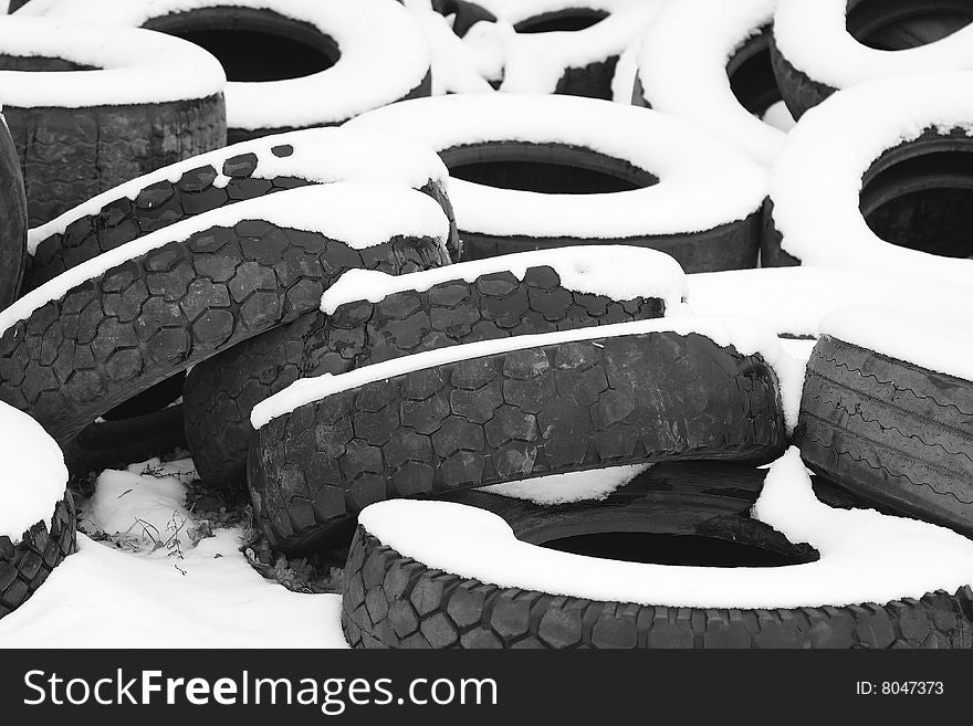 Snow-covered heap of old tires
