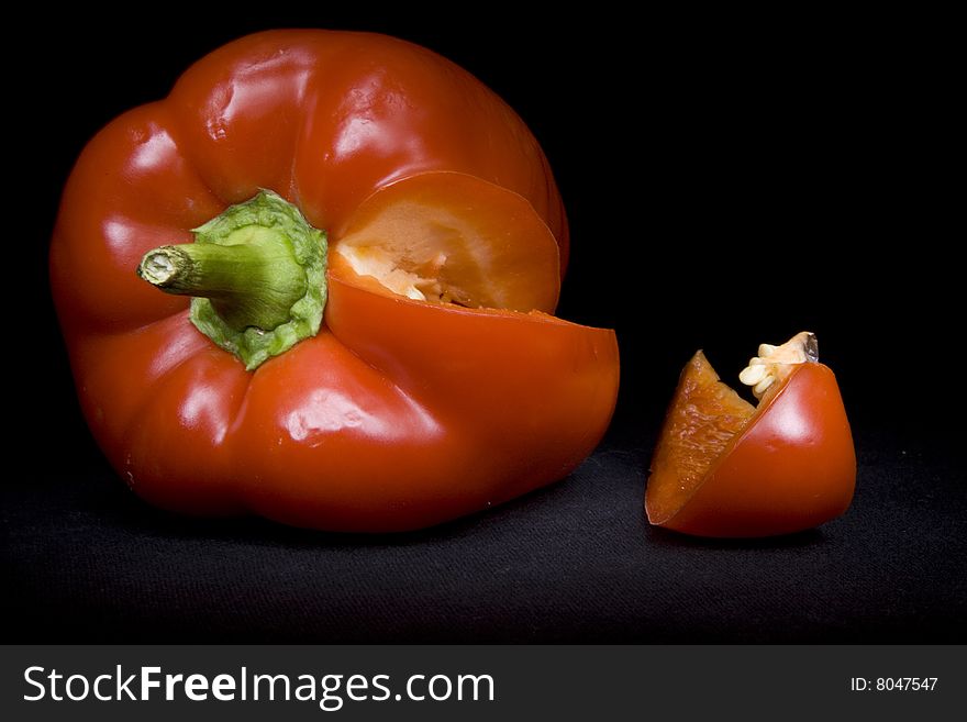 Red pepper on the black not isolated background