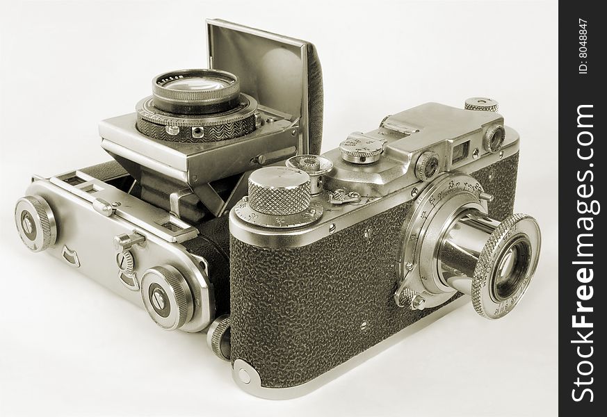 Two antiquarian 35-mm film cameras with put-forward lens. Two antiquarian 35-mm film cameras with put-forward lens.