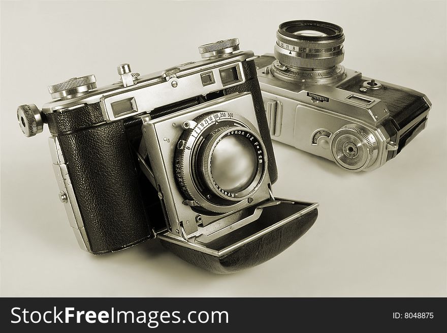 Two antiquarian 35-mm film cameras with put-forward lens. Two antiquarian 35-mm film cameras with put-forward lens.