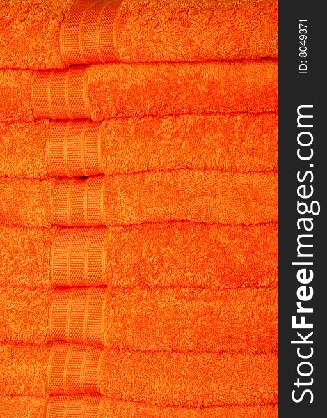 Big pile of soft thick orange towels